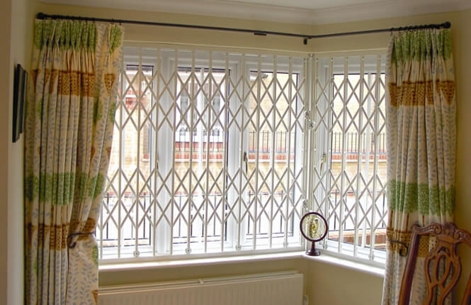 RSG1000 retractable security grilles on bay window of residential home in Kent.