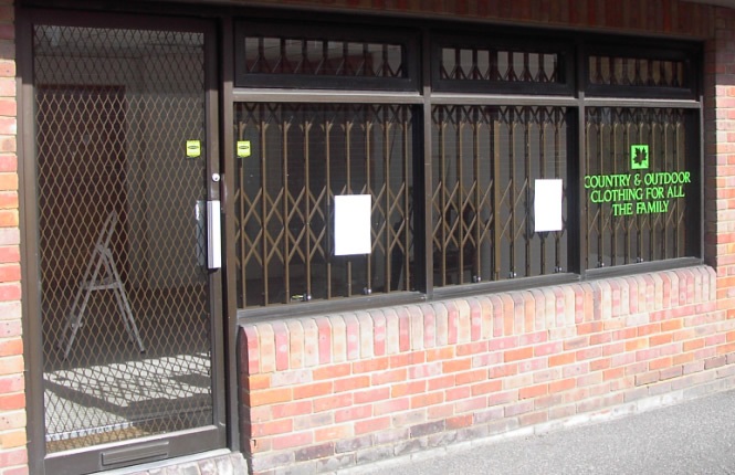 RSG800 fixed security mesh grilles on entrance door of commercial outlet in London.